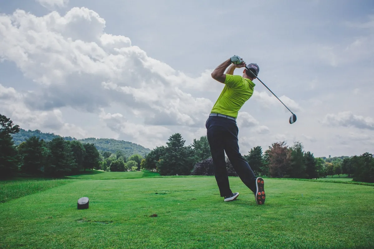 Golfer mid-swing on a manicured fairway